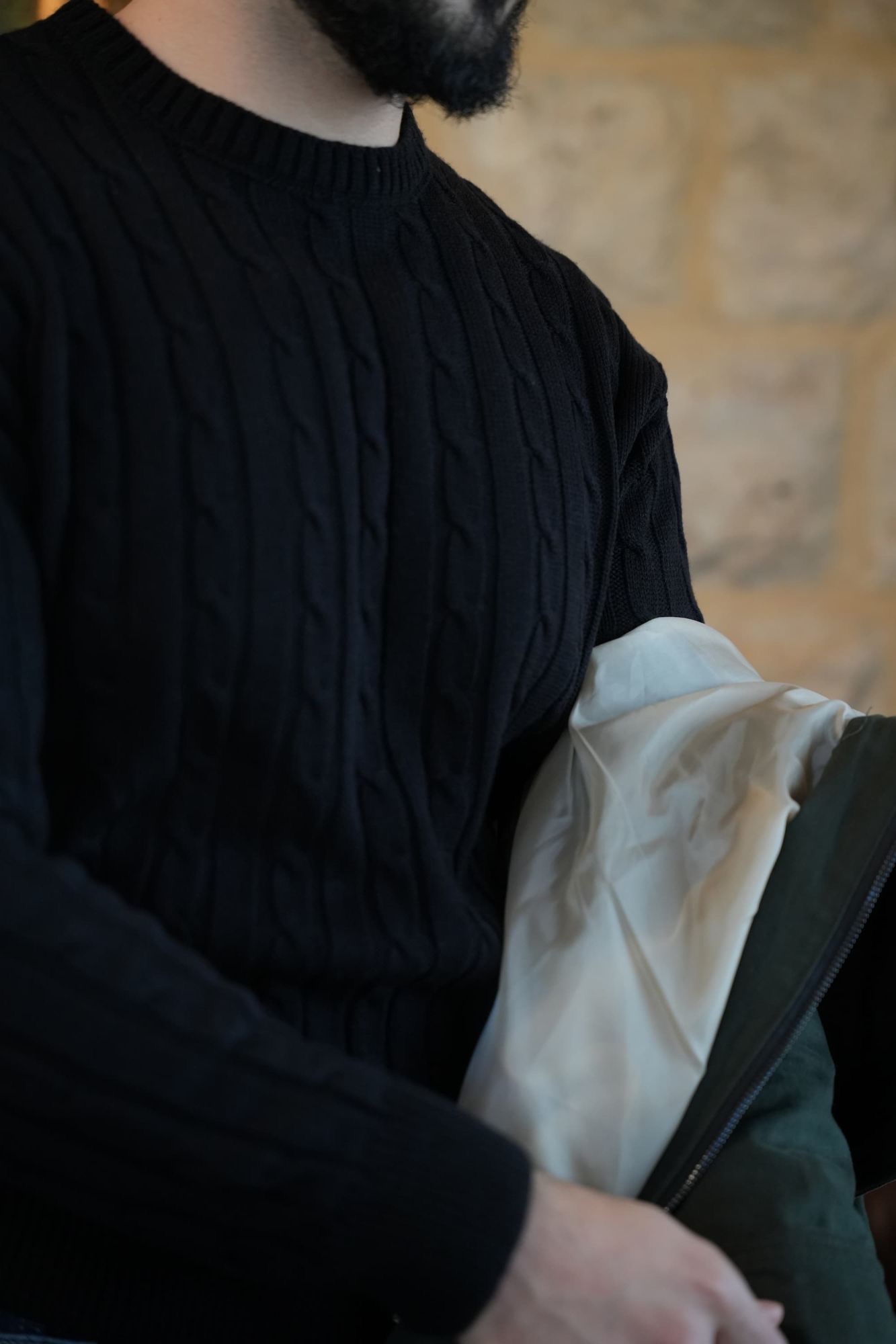 Black Cable-Knit Sweater with the Harrington Jacket's lining